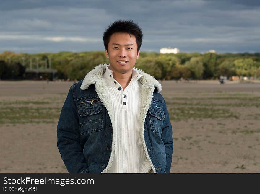 A boy standing on the woodbine beach wearing sports clothing. A boy standing on the woodbine beach wearing sports clothing