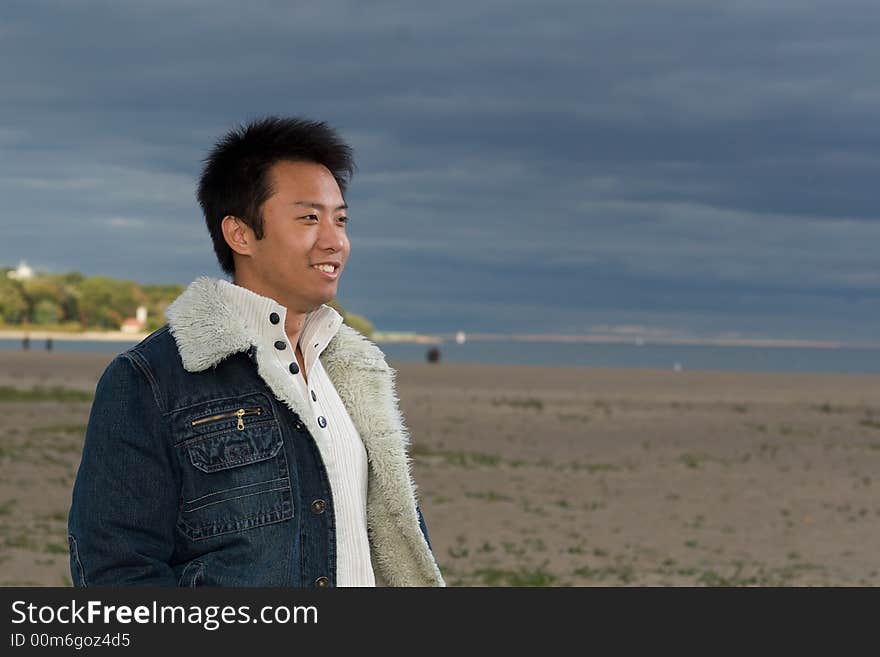 A boy standing on the woodbine beach wearing sports clothing