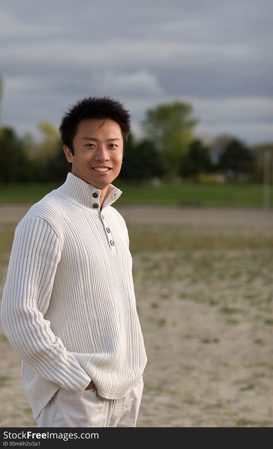 A boy standing on the woodbine beach wearing sports clothing. A boy standing on the woodbine beach wearing sports clothing