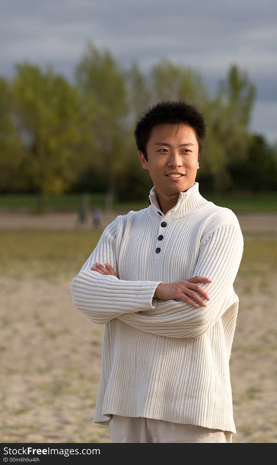 A boy standing on the woodbine beach wearing sports clothing. A boy standing on the woodbine beach wearing sports clothing