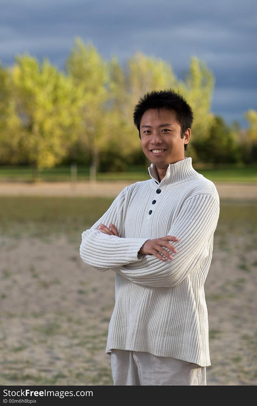 A boy standing on the woodbine beach wearing sports clothing. A boy standing on the woodbine beach wearing sports clothing