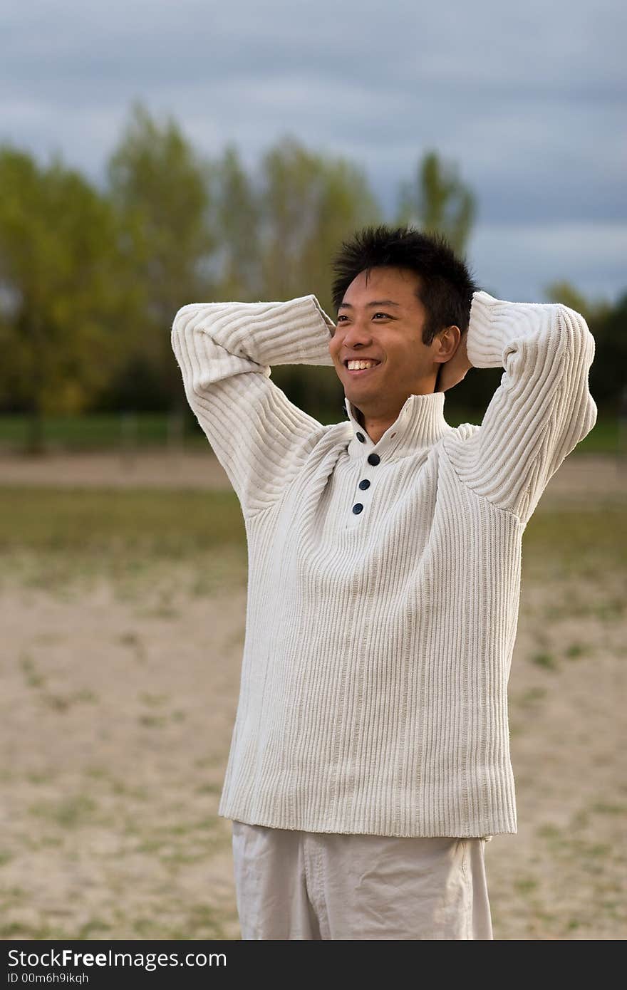 A boy standing on the woodbine beach wearing sports clothing. A boy standing on the woodbine beach wearing sports clothing