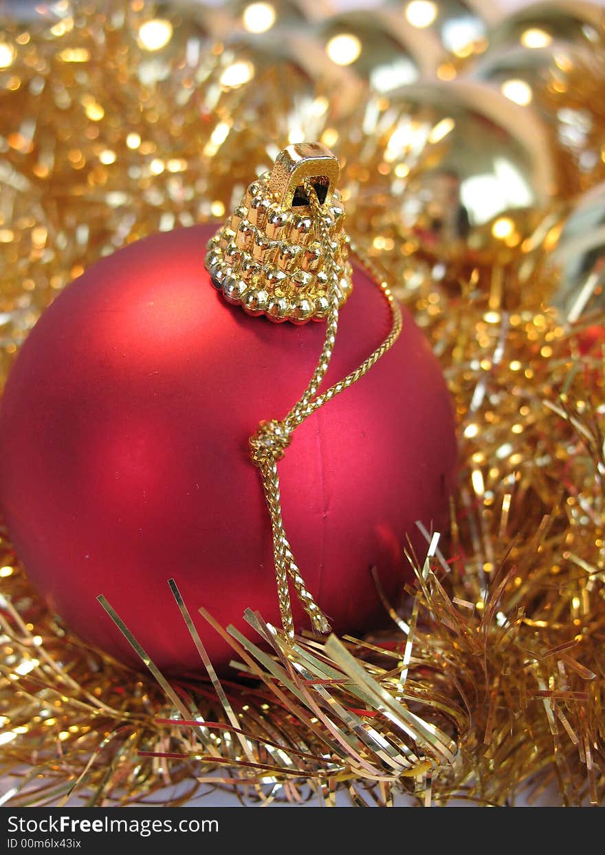 Red christmas ball on golden christmas balls background