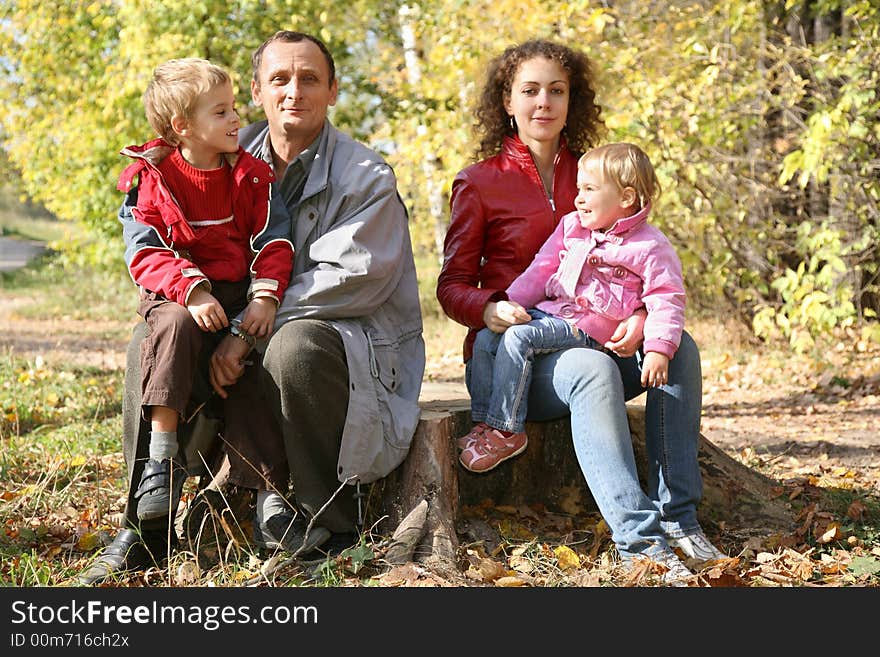 Mother with the daughter and the grandfather they sit in the park in autumn. Mother with the daughter and the grandfather they sit in the park in autumn