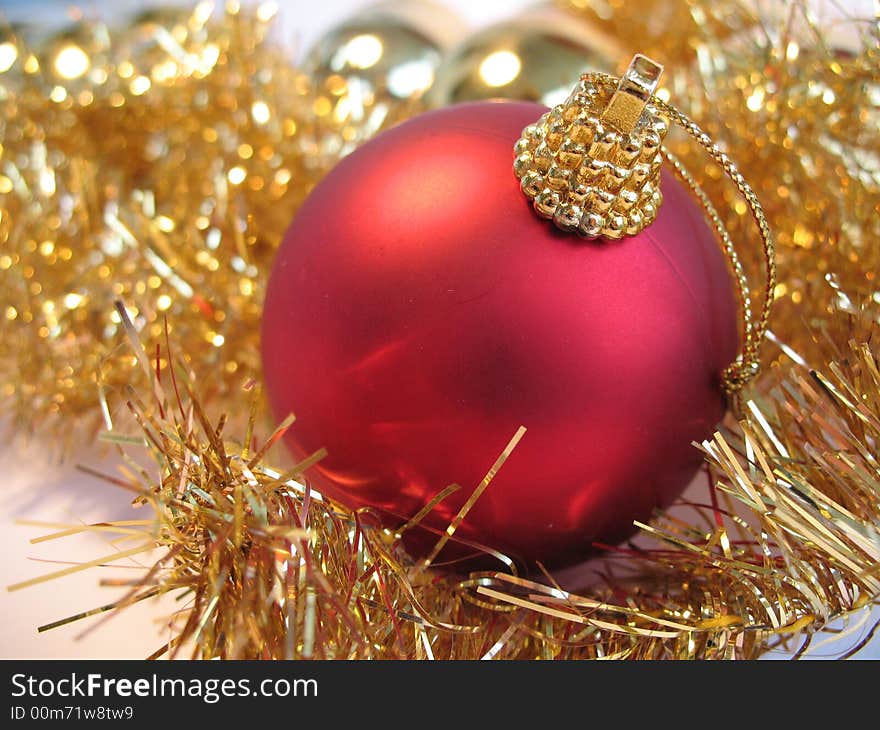 Red christmas ball on golden christmas balls background