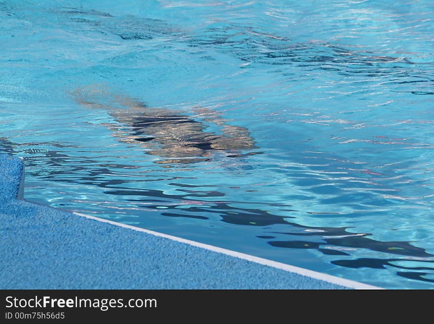 Figure of the sportsman in pool under water. Figure of the sportsman in pool under water