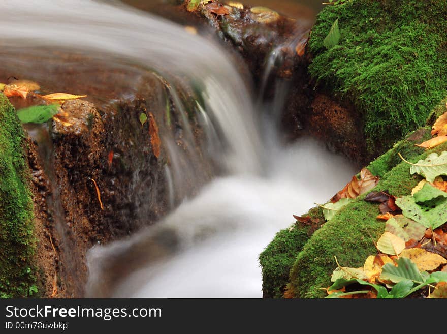 An image of little waterfall amongst stones. An image of little waterfall amongst stones