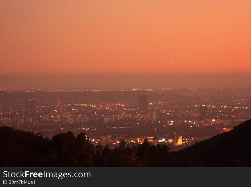 View of downtown Los Angeles and surrounding area during a beautiful orange glowing sunset. View of downtown Los Angeles and surrounding area during a beautiful orange glowing sunset.