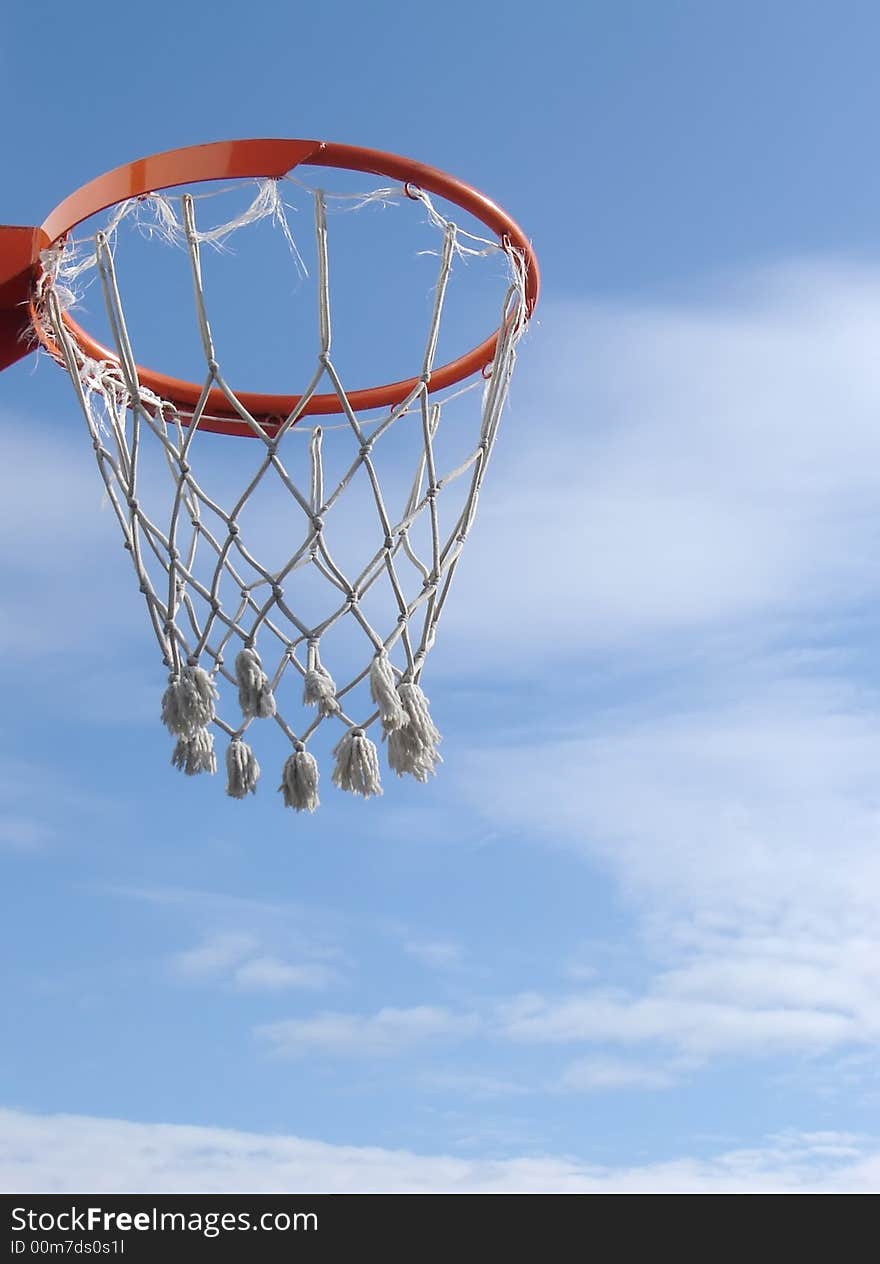 New basketball hoop against blue sky