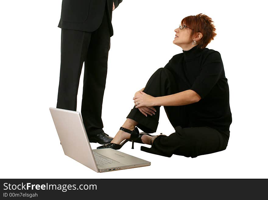 Thirties woman with laptop, man standing beside her.