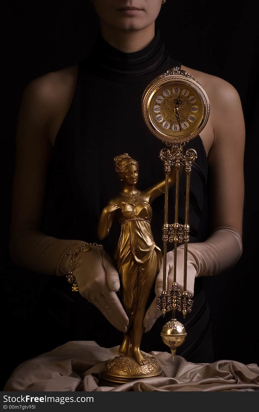 Sepia picture of a beautiful girl with antique clock