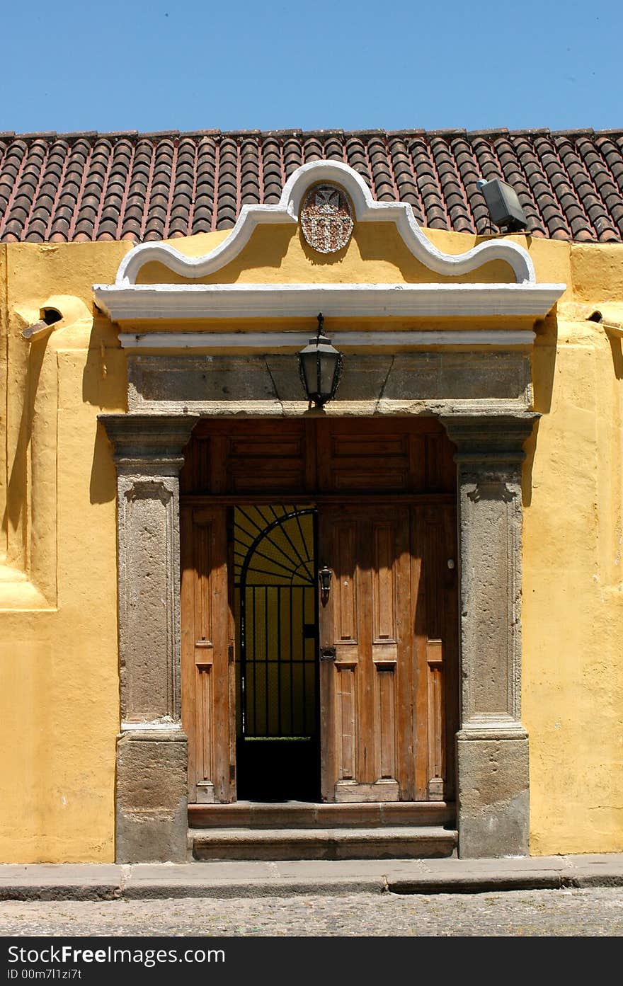 An old yellow house with a stone decorated house. An old yellow house with a stone decorated house