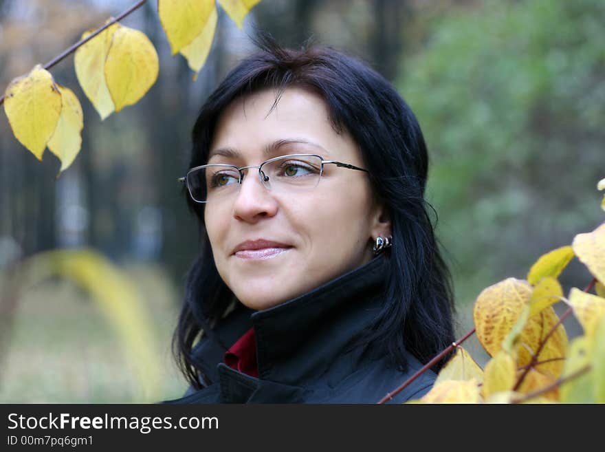 Young woman with black hair in glasses, autumn shot. Young woman with black hair in glasses, autumn shot