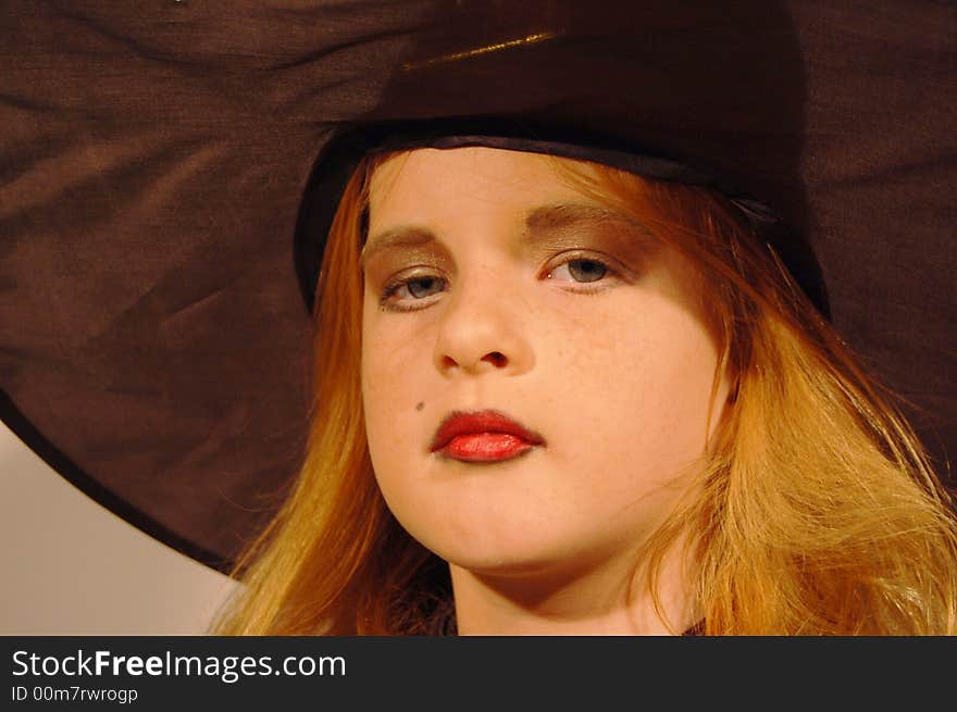 Young girl as witch with witch head