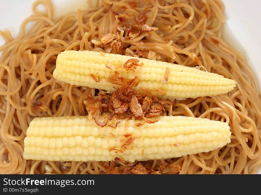 Brown Chinese buckwheat noodles with baby corn in light soup