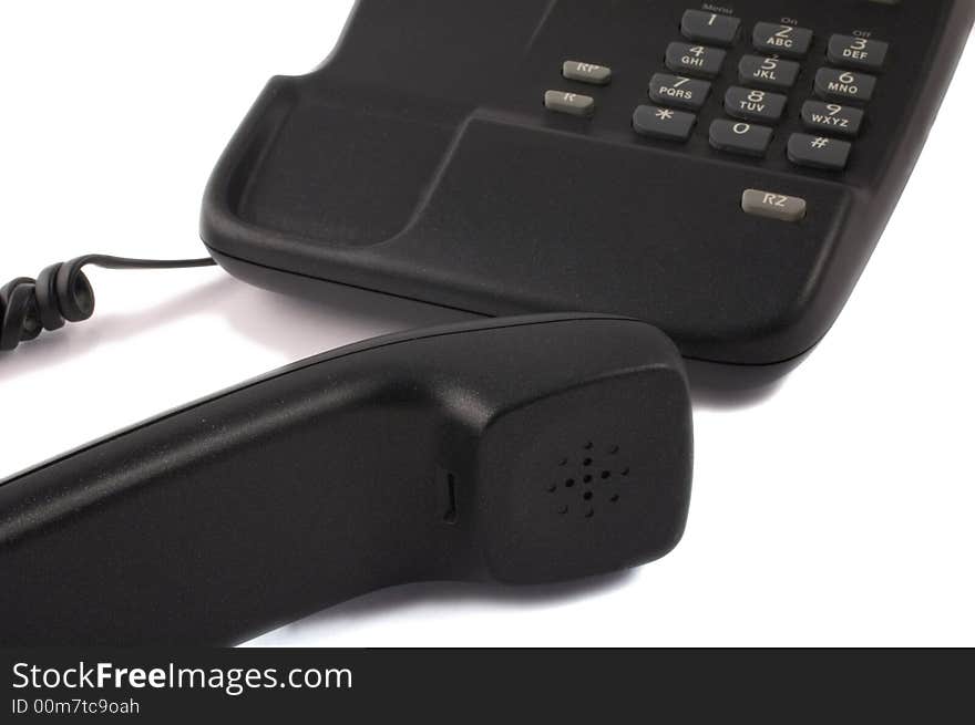 Black telephone with receiver in foreground isolated on white. Black telephone with receiver in foreground isolated on white