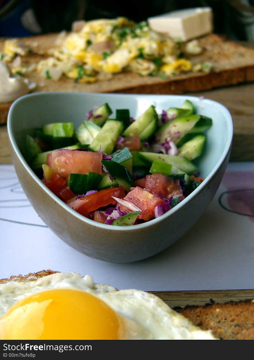 Close up of fresh breakfat with bread, salad and fried egg. Close up of fresh breakfat with bread, salad and fried egg.