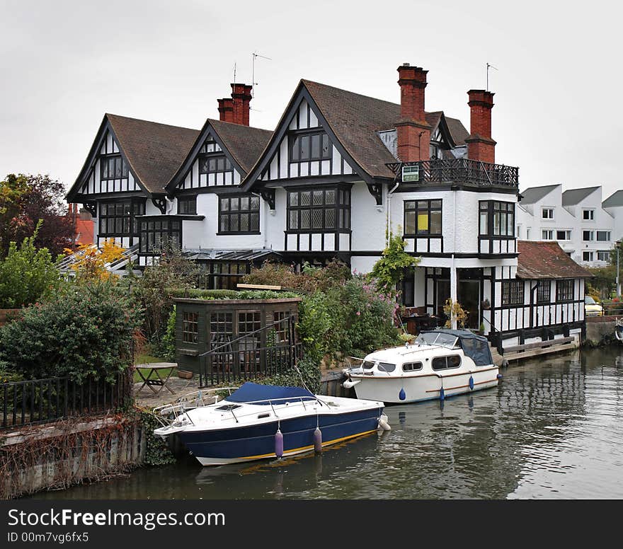 Timber Framed Houses and Moored Boats on the River Thames in England. Timber Framed Houses and Moored Boats on the River Thames in England