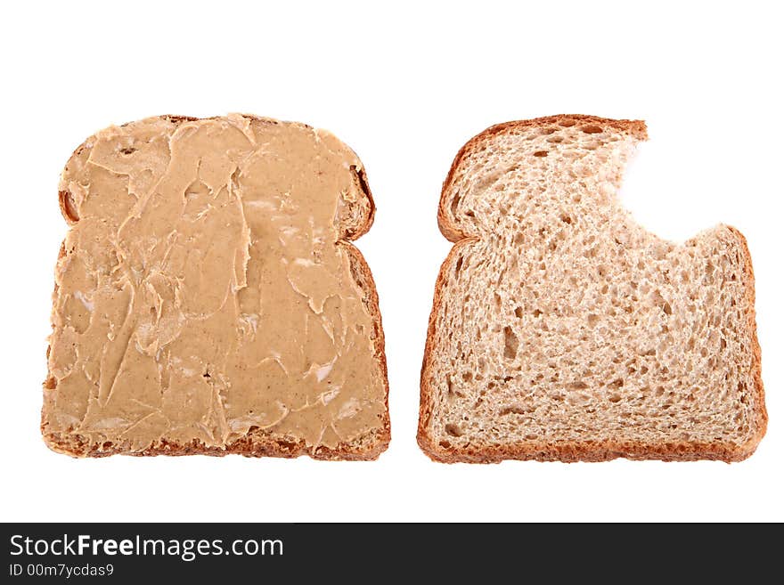 Two slice of bread, the first one is buttered but the second is bitten. Two slice of bread, the first one is buttered but the second is bitten