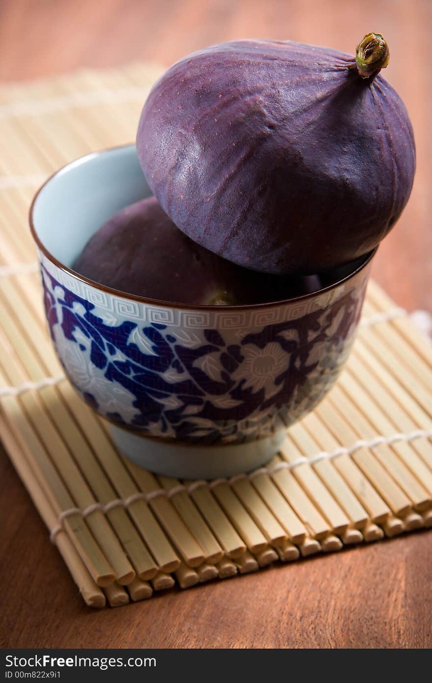 Fresh figs on the bamboo mat background