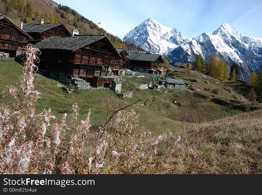 Mountain village during fall season; west Alps, Italy