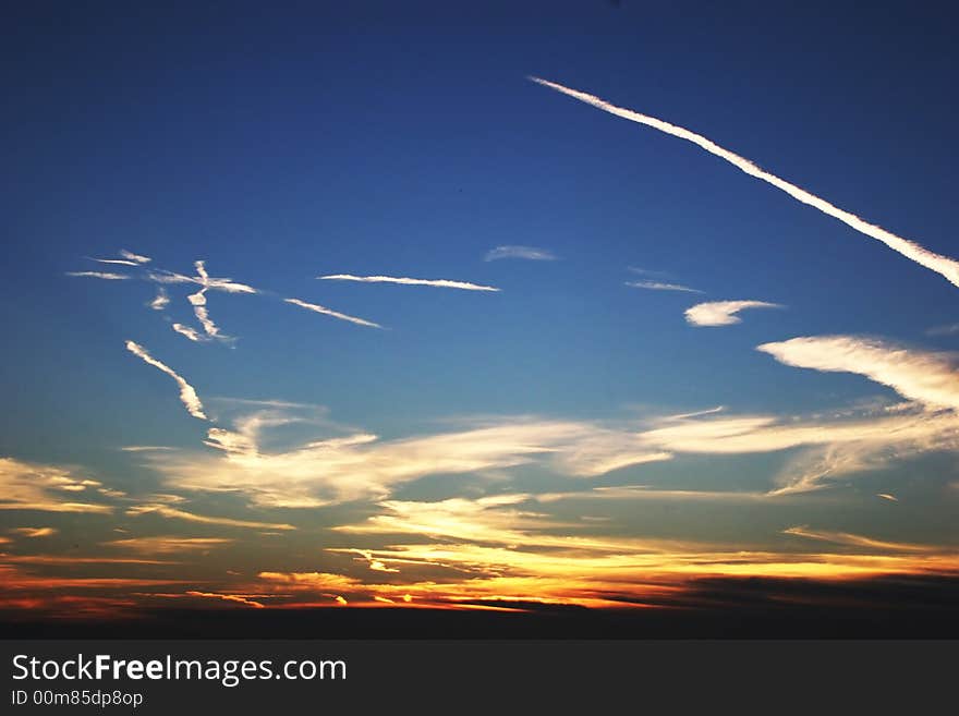 Nature colors, sunrise with tracks in the clouds