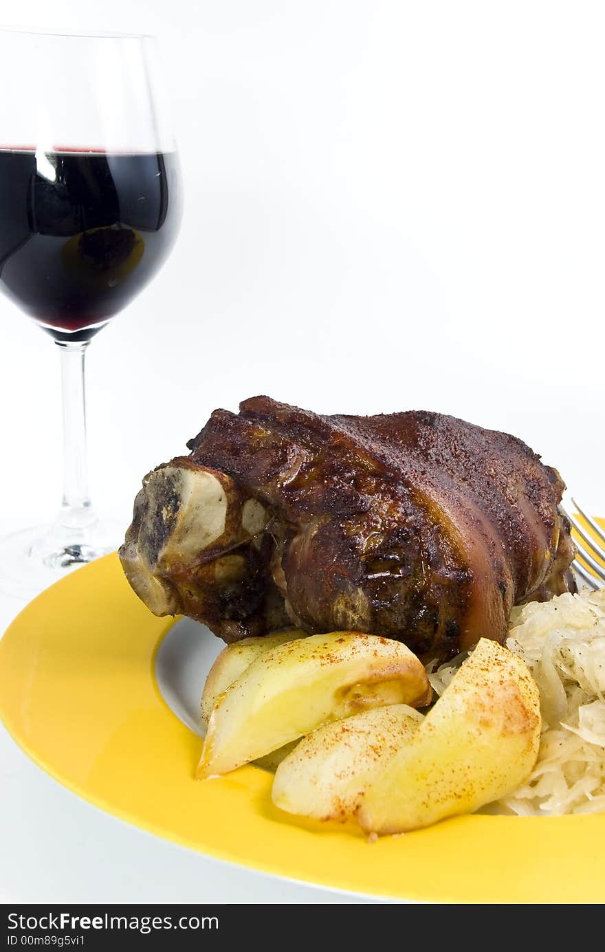 Grilled pork knuckle with deep fried potatoes,sauerkraut and wine. Grilled pork knuckle with deep fried potatoes,sauerkraut and wine.