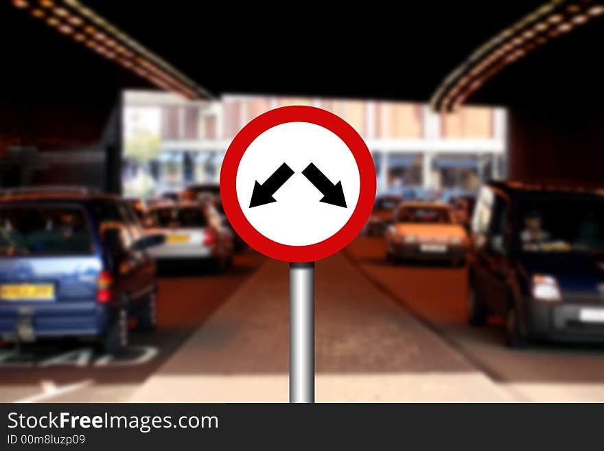 Road traffic sign with two arrows and blurred traffic in background