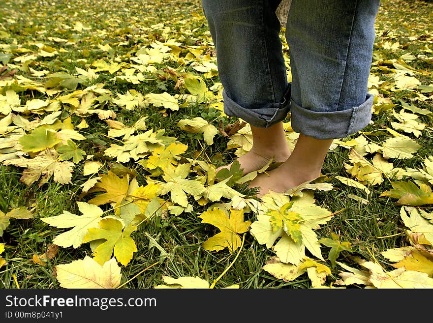 A view with bare feet resting on grass. A view with bare feet resting on grass