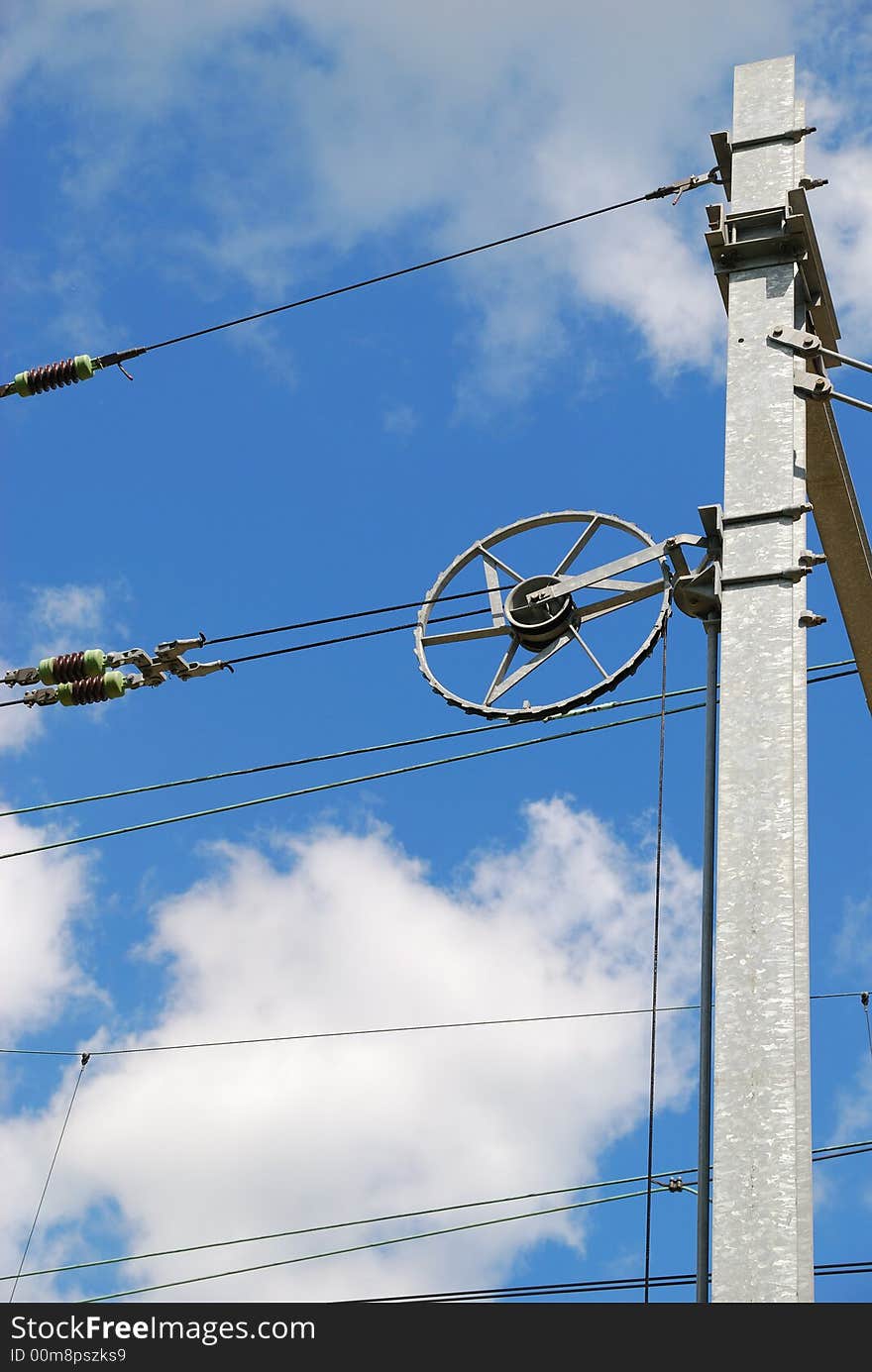 Track electricity line tensioner with blue sky and white clouds