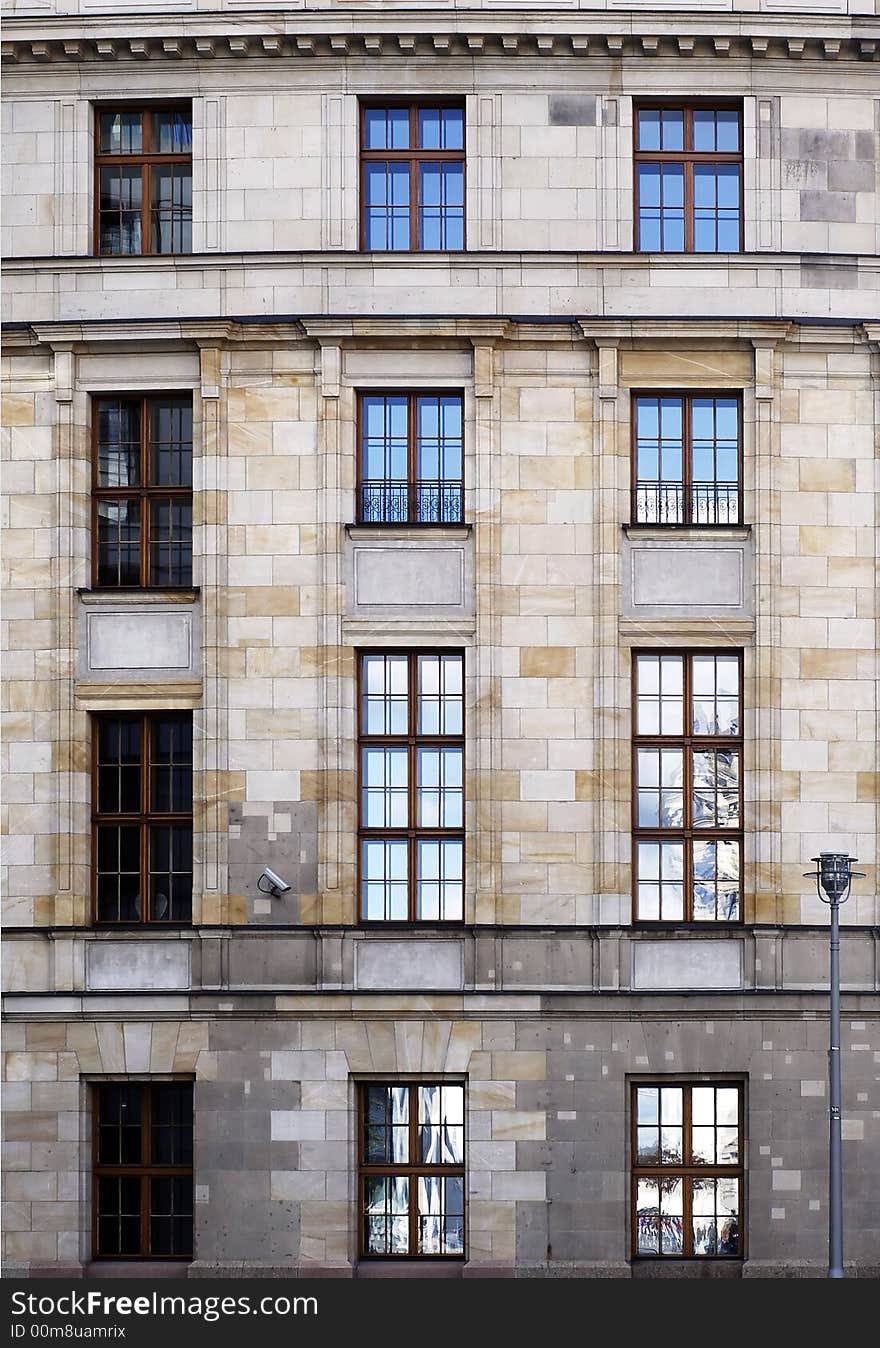 Wall with shiny windows with sky and clouds reflexion. Wall with shiny windows with sky and clouds reflexion