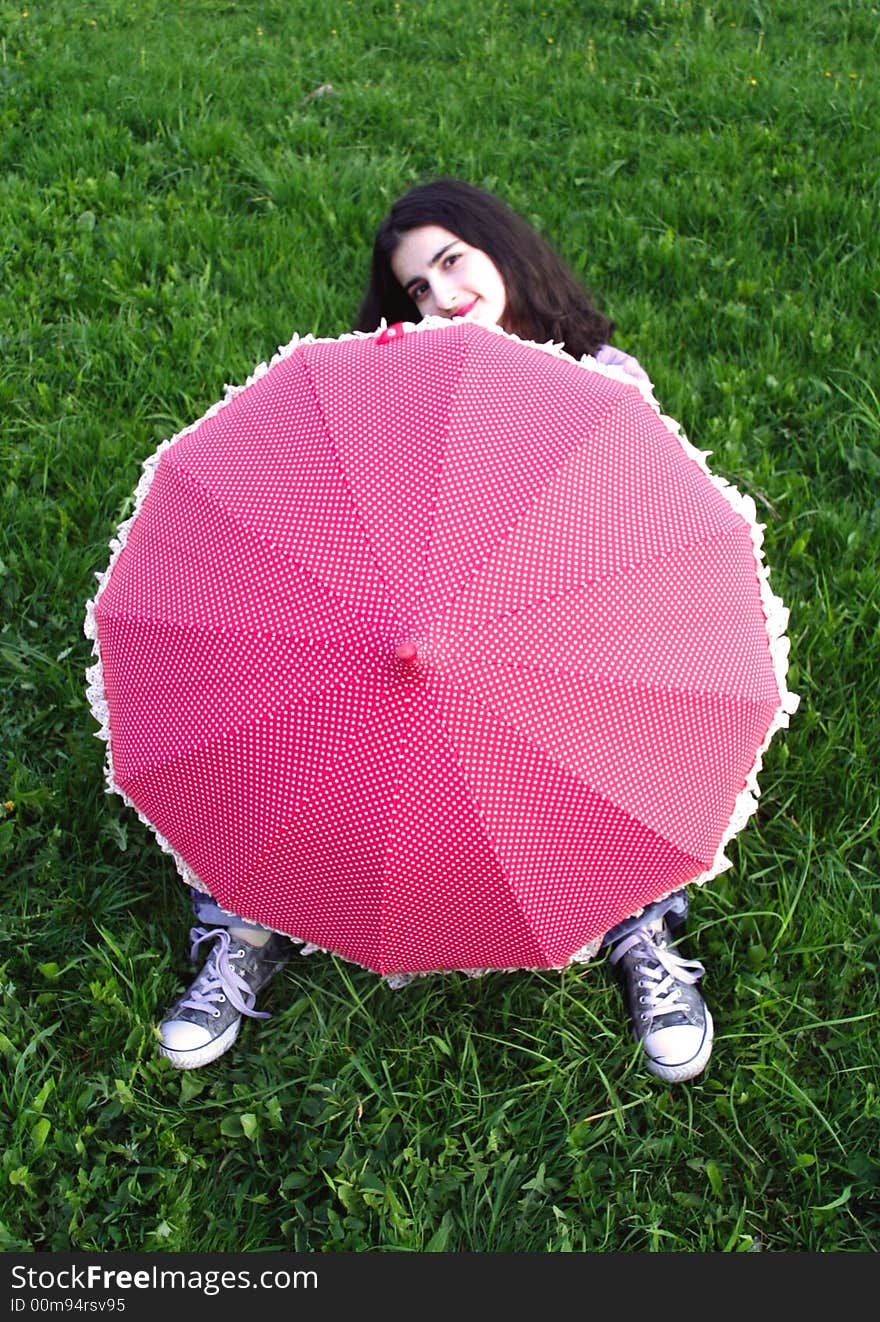 A girl under the red umbrella. A girl under the red umbrella