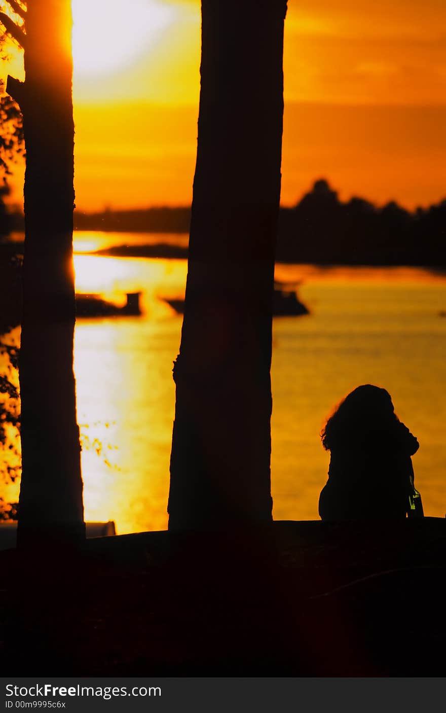 Sunset at a Finish harbor with young woman. Sunset at a Finish harbor with young woman