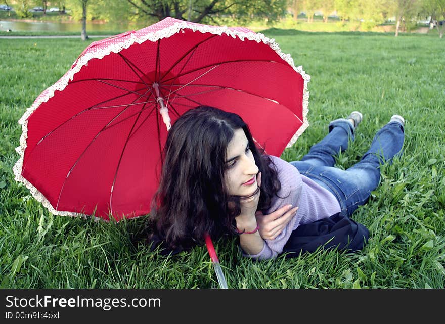 Next to a red umbrella