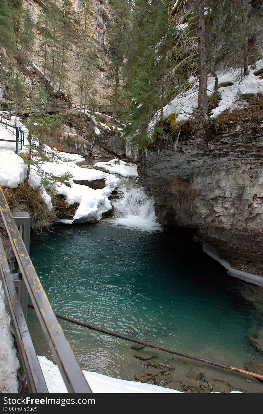 Beautiful parcially frozen stream through a deep canyon in the Canadian Rocky Mountains. Beautiful parcially frozen stream through a deep canyon in the Canadian Rocky Mountains.