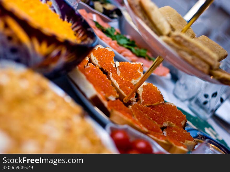 Sandwiches with red caviar on the served table