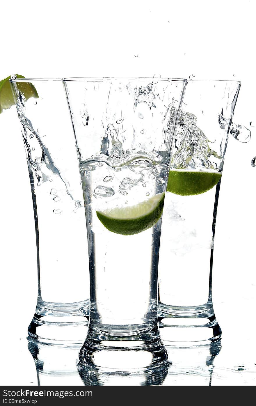 Glass with water and lemon on the white background