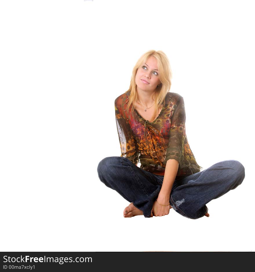 Beautiful blond girl sitting on the floor