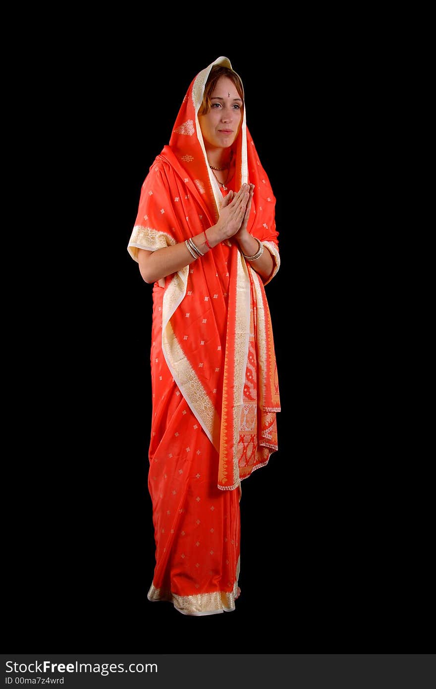 Young girl praying in indian dress. Young girl praying in indian dress