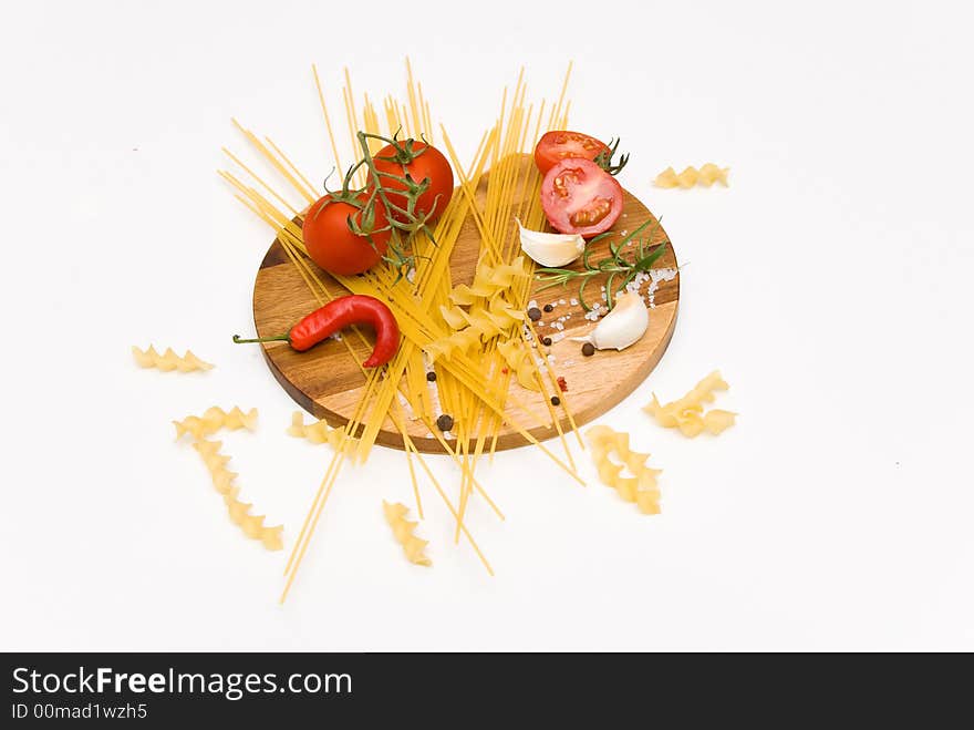 Pastaingredients on a wooden plate with spices. Pastaingredients on a wooden plate with spices