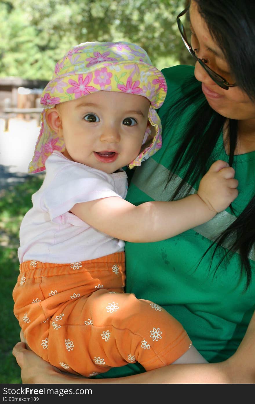 8 Months old Baby Girl Hugging Mom. 8 Months old Baby Girl Hugging Mom