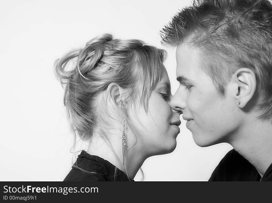 Couple of teenagers in the studio on a white background. Couple of teenagers in the studio on a white background