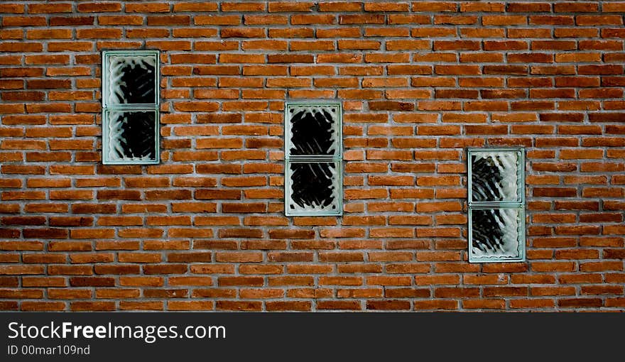 3 windows in a brick wall in diagonal