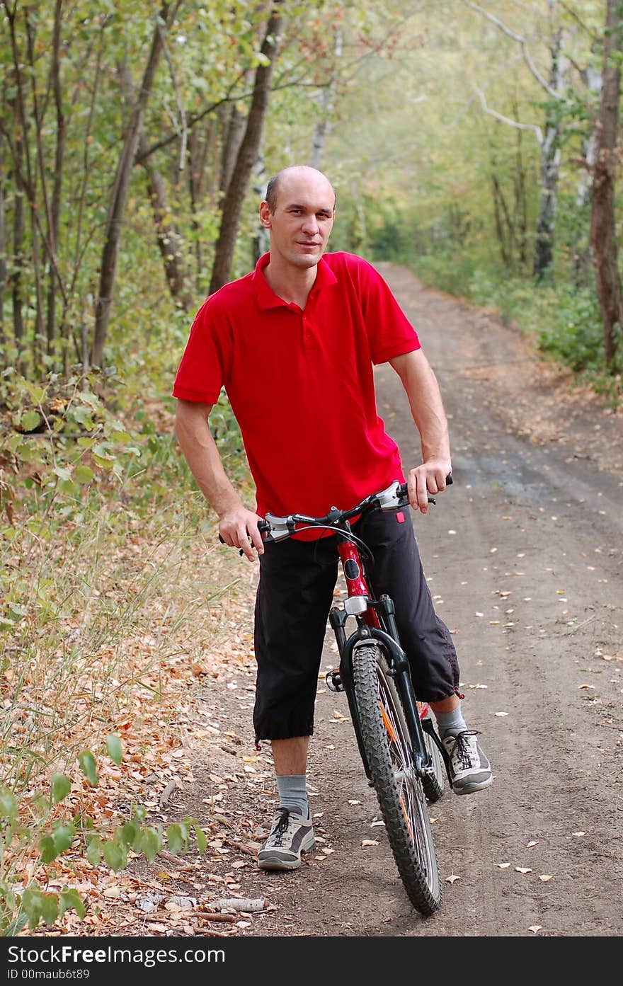 Man biking in autumn forest