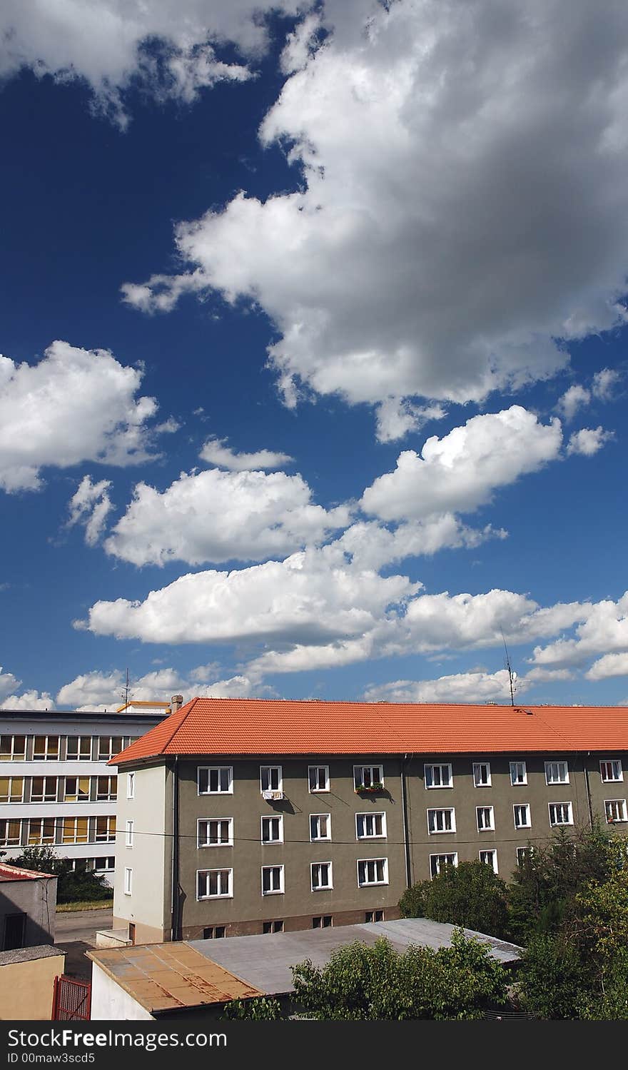 House in town with dramatic clouds