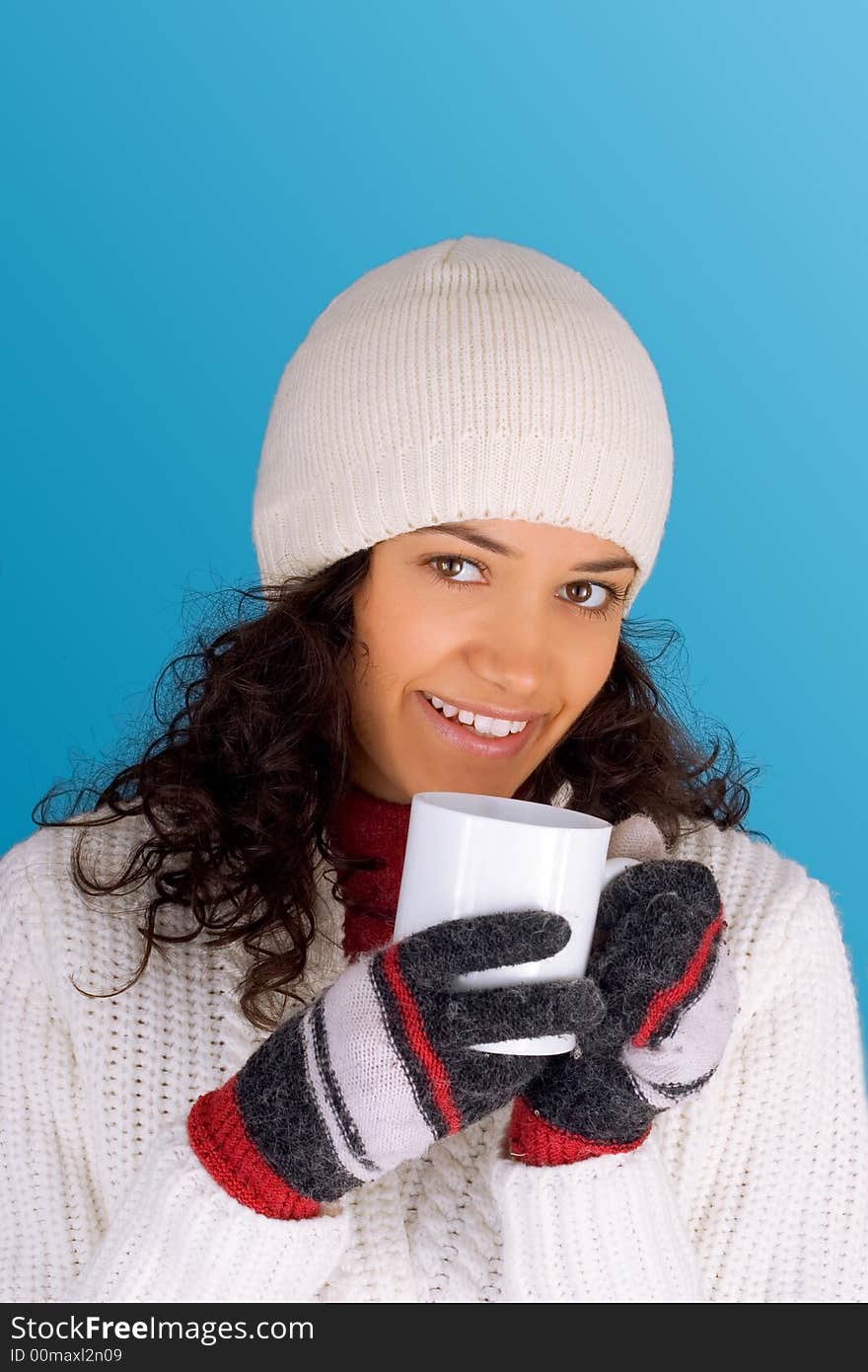 Winter girl drinking tea isolated on blue background