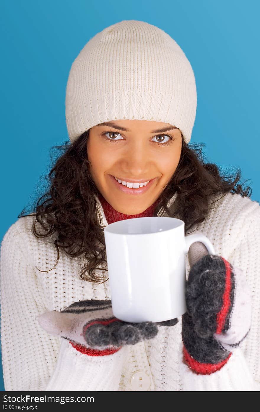 Winter girl drinking tea isolated on blue background