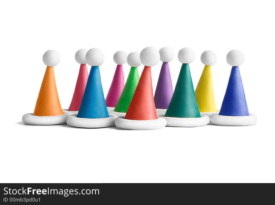 Multicolored plasticine Santa hats on a white background. Multicolored plasticine Santa hats on a white background