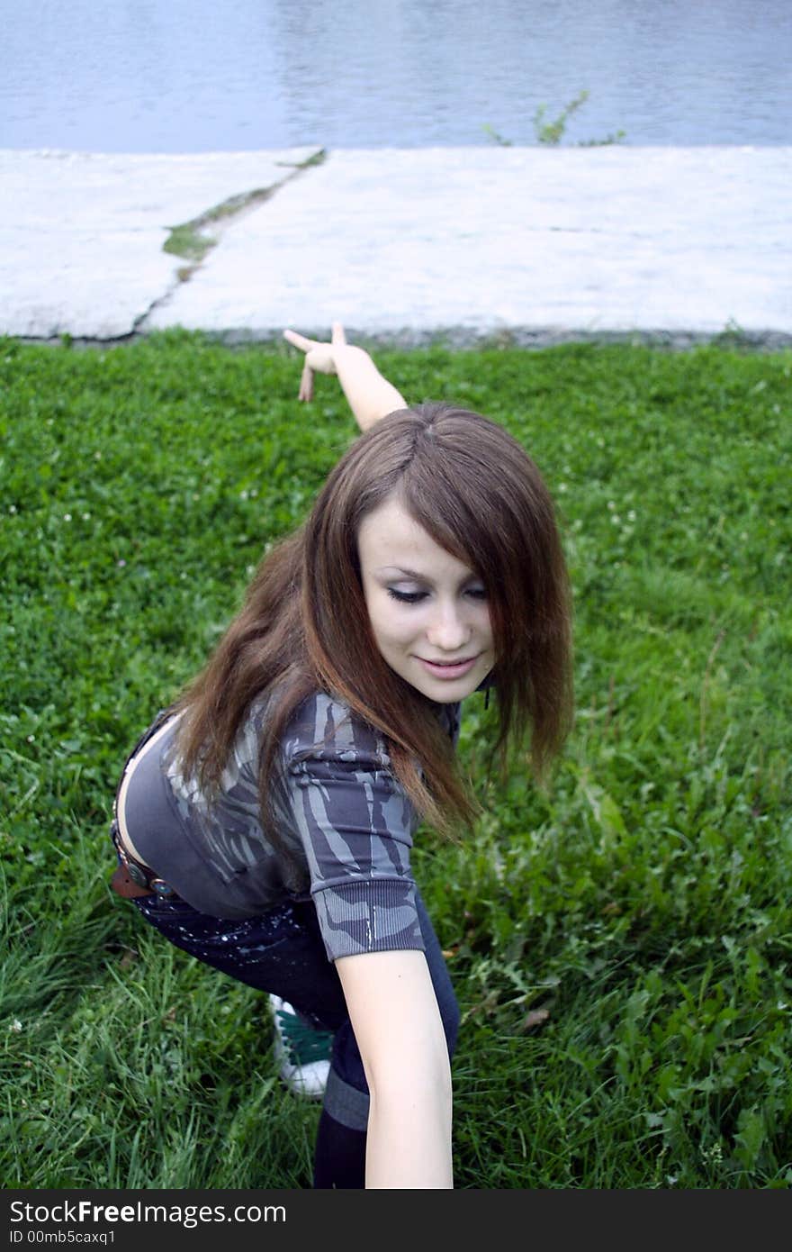 A girl dancing on the green lawn