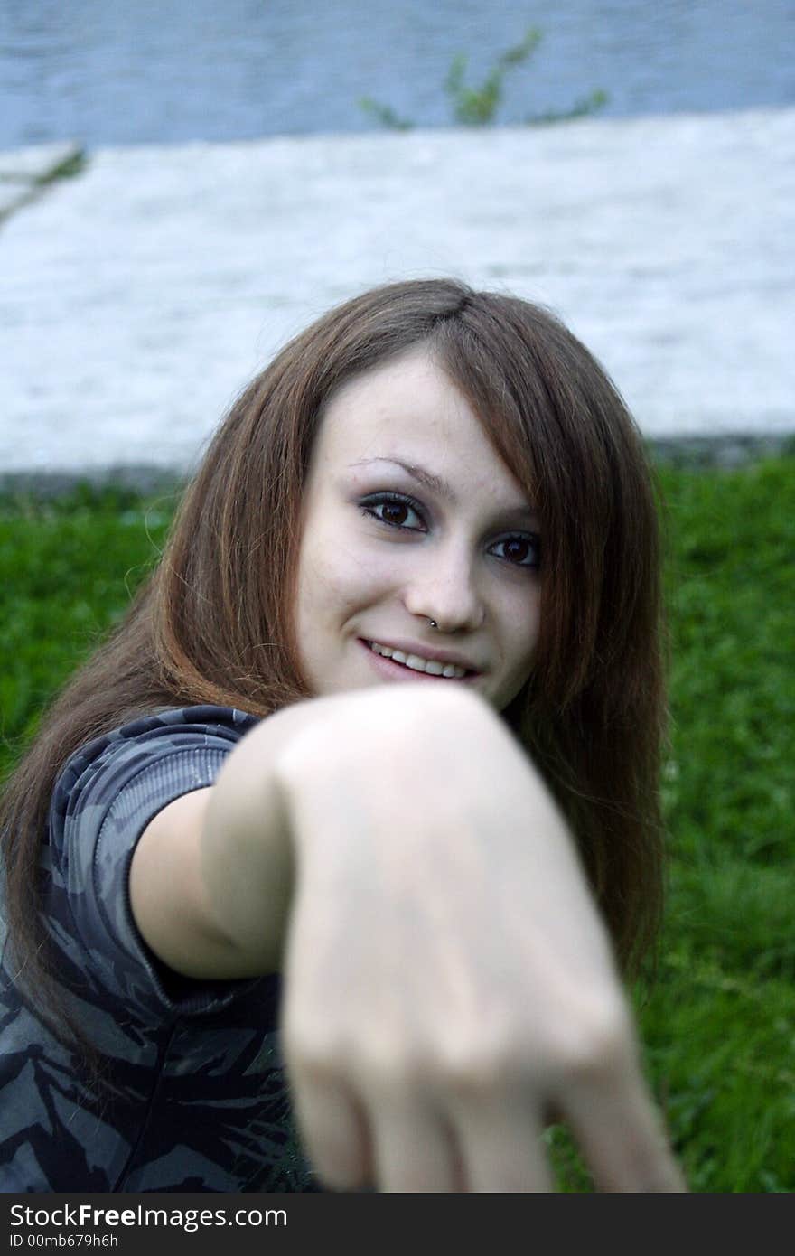 A girl holding her hand towards. A girl holding her hand towards